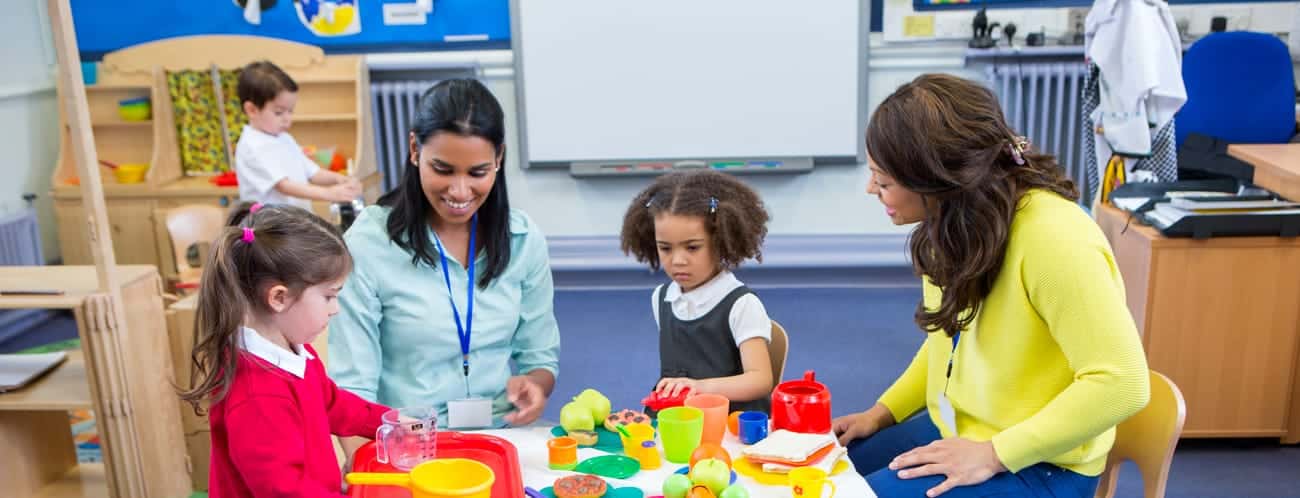 Childcare providers teaching preschoolers